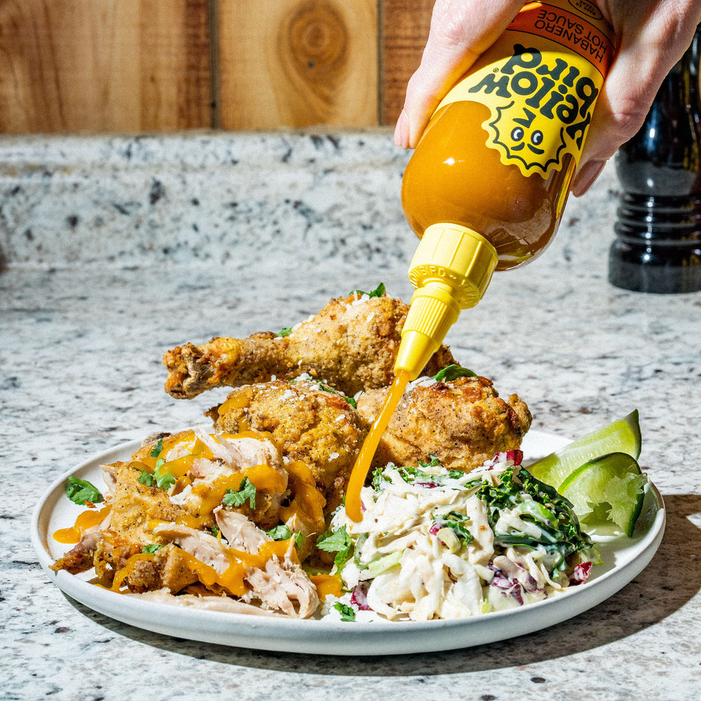 Yellowbird Classic Habanero Hot Sauce on air fryer fried chicken and coleslaw