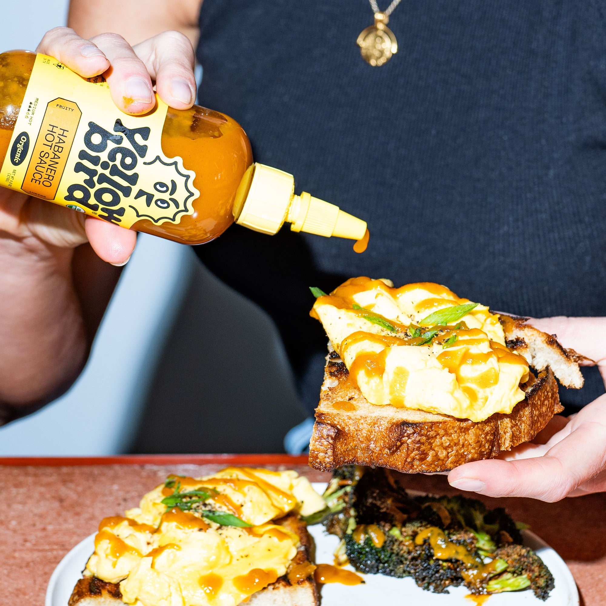 Yellowbird Organic Habanero Hot Sauce drizzled onto fluffy scrambled egg toast